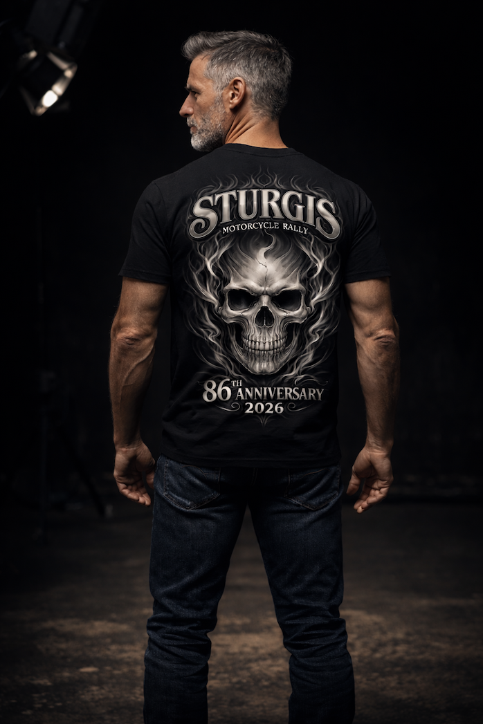 Rider on a Harley facing Mount Rushmore at golden hour, wearing the 2026 Sturgis Iron Bison tee