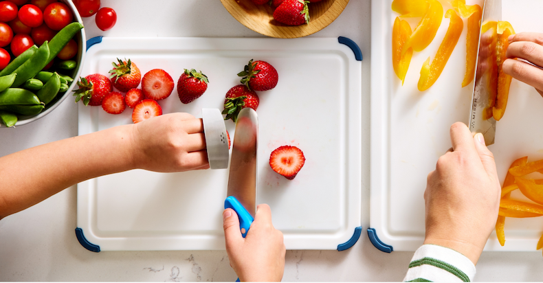 Kid's knife cutting strawberries