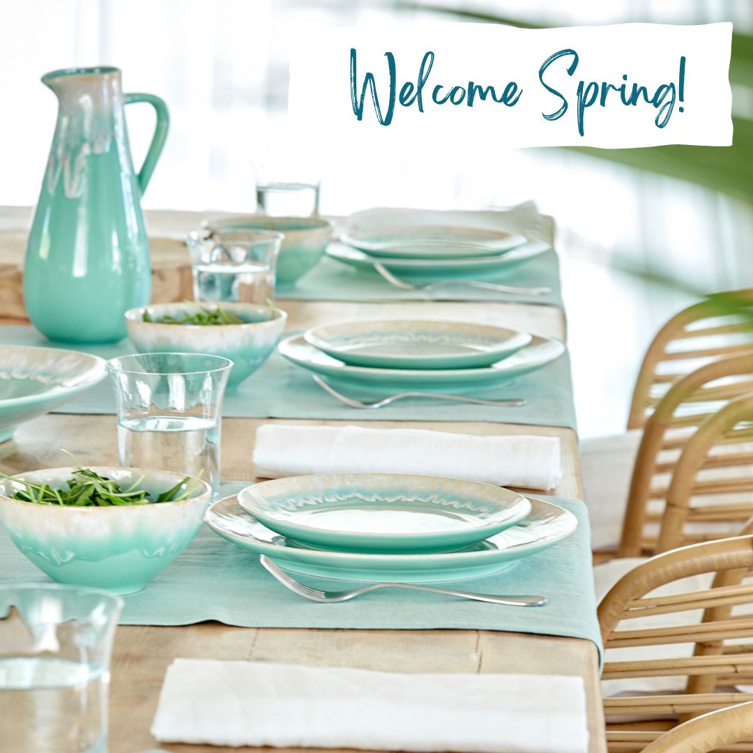 an image of a table set with Fine Stoneware plates and glasses and a welcome spring sign